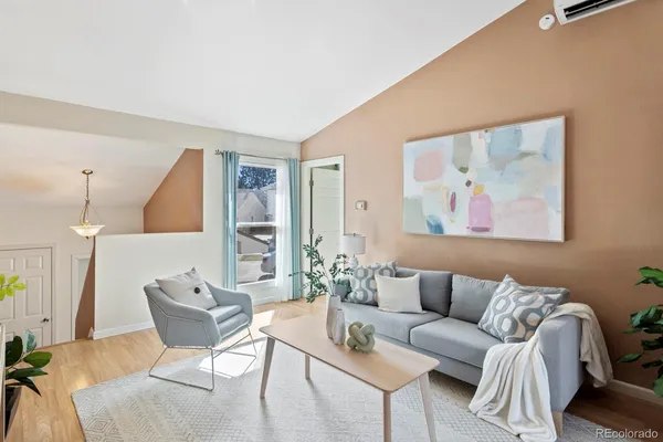 a living room with furniture and a painting