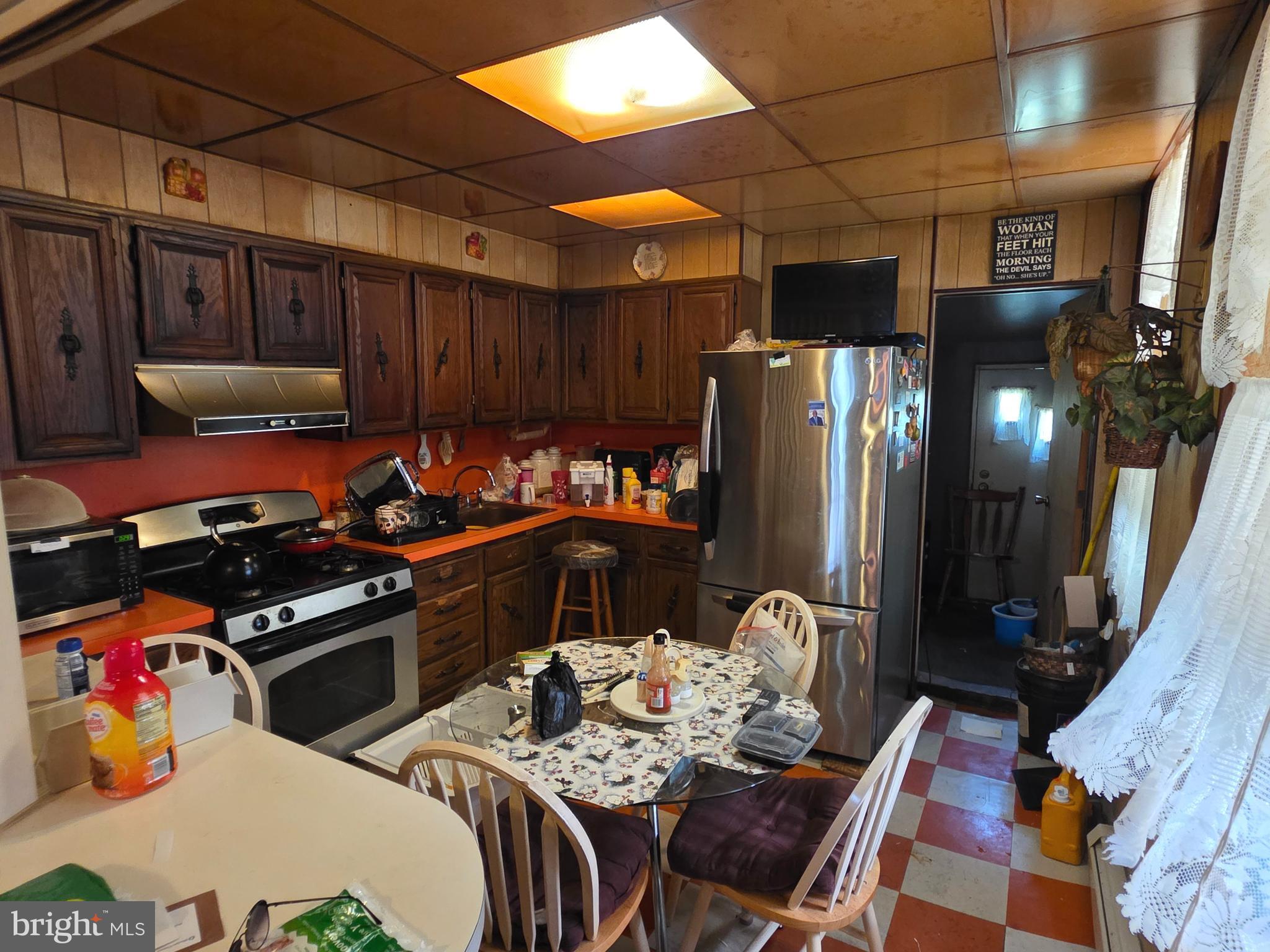 1317 East Rittenhouse Street Philadelphia, PA 19138 - Photo 5 of 16 a kitchen with stainless steel appliances a stove a refrigerator and a dining table