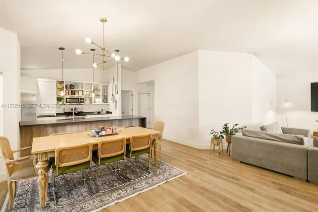 a kitchen with stainless steel appliances granite countertop a sink a stove and a wooden cabinets