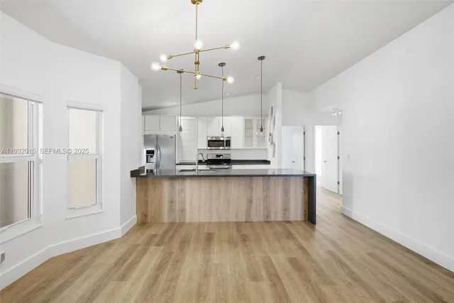 a kitchen with stainless steel appliances a sink stove and refrigerator
