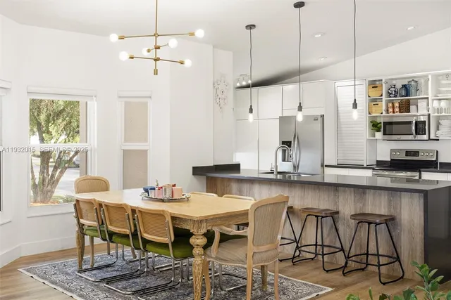 a kitchen with stainless steel appliances granite countertop a refrigerator and a stove