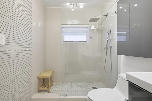 a bathroom with a shower and a sink