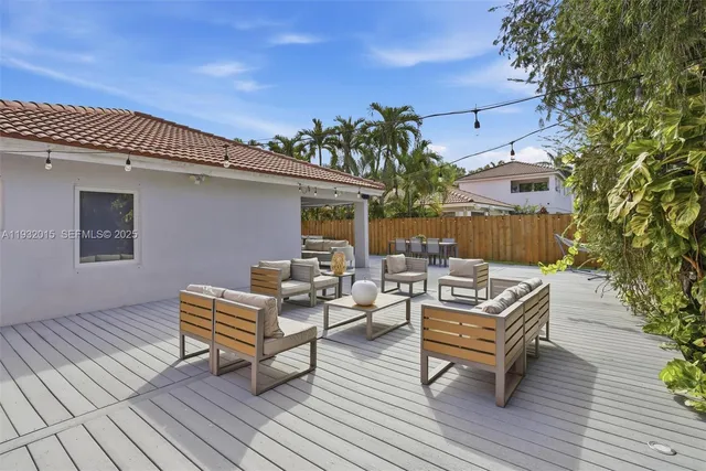 a view of a patio with couches and potted plants