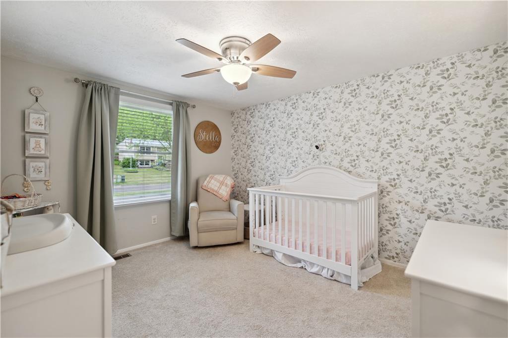 131 Fox Run Road Cranberry Township, PA 16066 - Photo 18 of 31 The second bedroom at the front of the home currently used as a nursery has a beautiful accent wall, newer ceiling fan and wall to wall carpeting.
