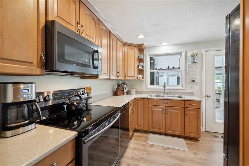 131 Fox Run Road Cranberry Township, PA 16066 - Photo 7 of 31 Transitioning from the living room into the kitchen and dining area reveals an updated space with quartz countertops and newer appliances.
