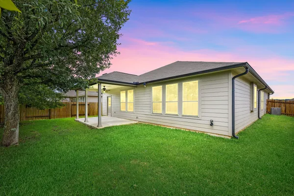 a view of a house with a yard and a porch