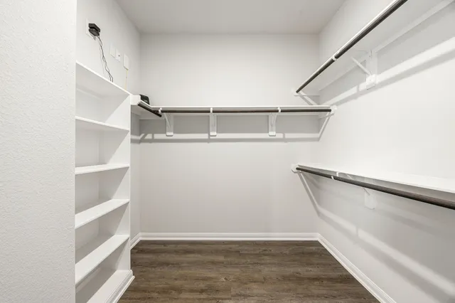 a view of walk in closet with empty racks
