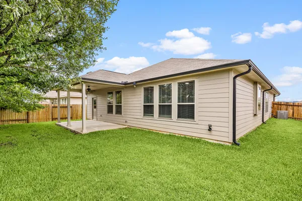 a view of a house with a backyard