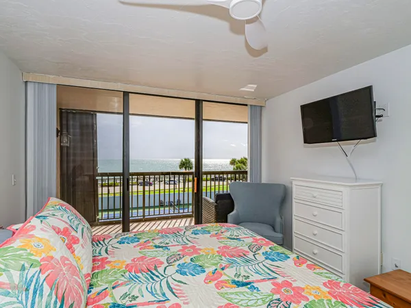 a bedroom with a bed and flat screen tv