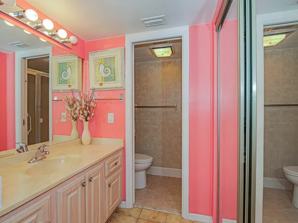 a bathroom with a sink a toilet a shower and a mirror