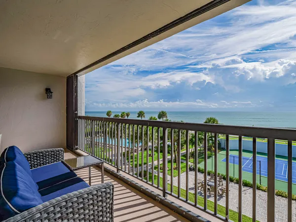 a balcony with wooden floor and outdoor view