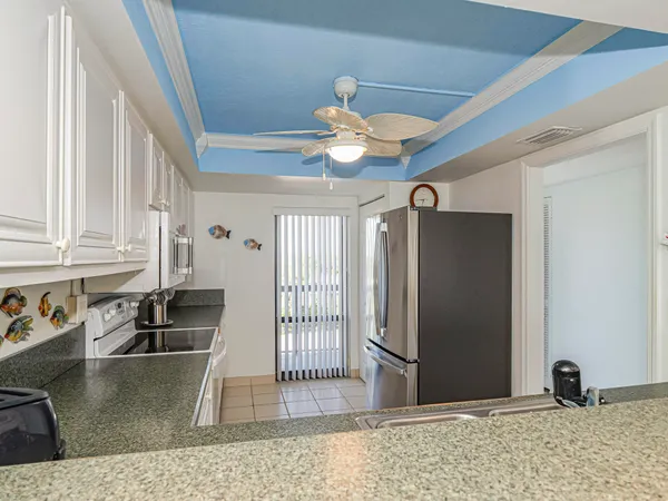 a view of a livingroom with wooden floor and a ceiling fan