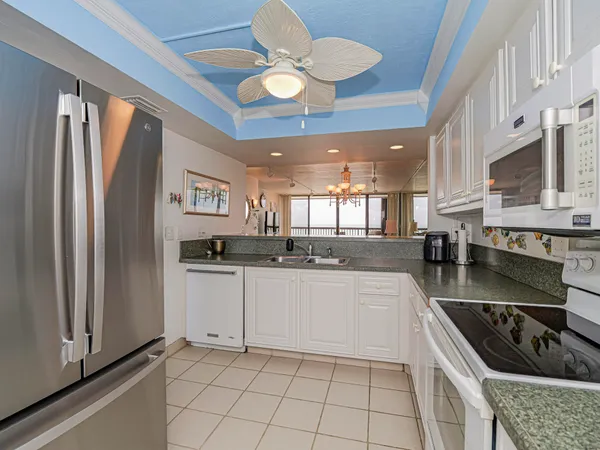 a kitchen with stainless steel appliances granite countertop a stove a sink and a refrigerator