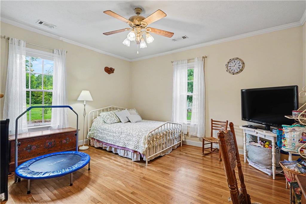 355 Inman Road Hampton, GA 30228 - Photo 25 of 47 a bedroom with a bed and a flat screen tv