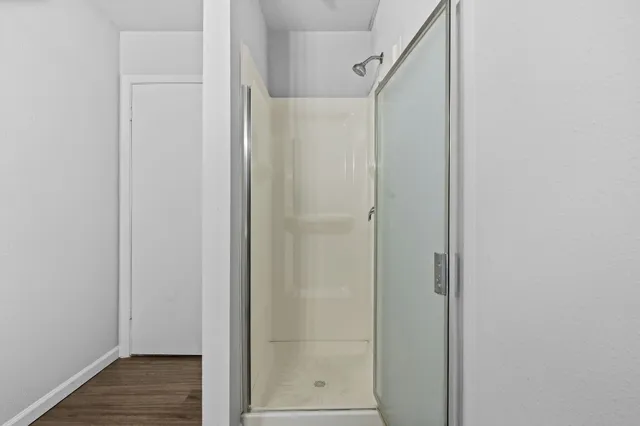 a bathroom with a glass shower door