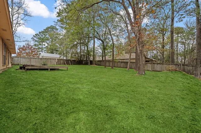a view of a yard with a house in the background