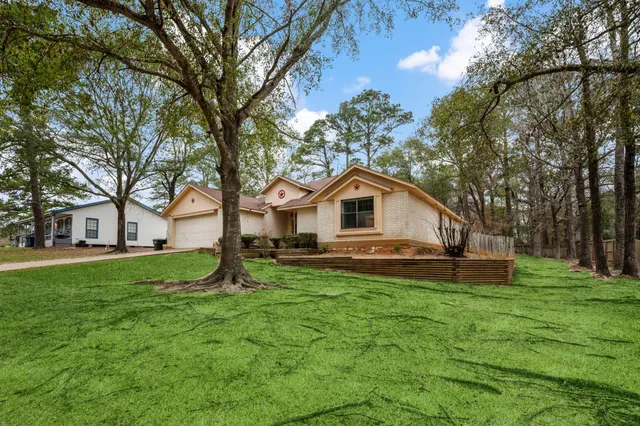 a front view of house with yard and green space