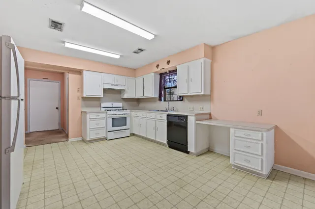 a kitchen with stainless steel appliances cabinets a sink and a stove