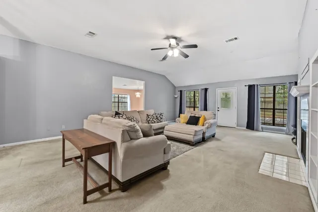 a living room with furniture and white walls