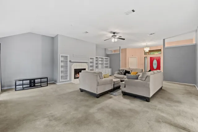 a living room with furniture and a fireplace