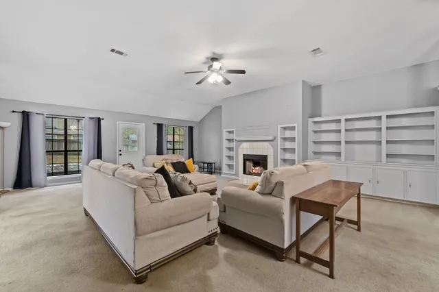 a living room with furniture and a fireplace