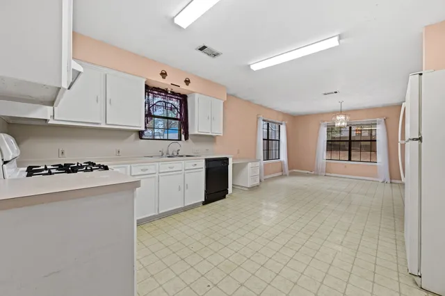 a kitchen with a stove a sink and a refrigerator