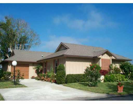 5625 Southeast Miles Grant Road Stuart, FL 34997 - Photo 1 of 1 a front view of a house with a yard