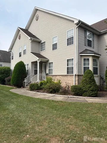 a front view of house with yard and green space
