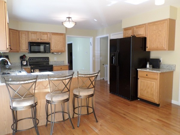 580 R Water Street Framingham, MA 01701 - Photo 3 of 17 a kitchen with stainless steel appliances kitchen island granite countertop a refrigerator and a stove top oven
