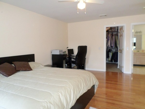 580 R Water Street Framingham, MA 01701 - Photo 9 of 17 a bedroom with a bed and wooden floor