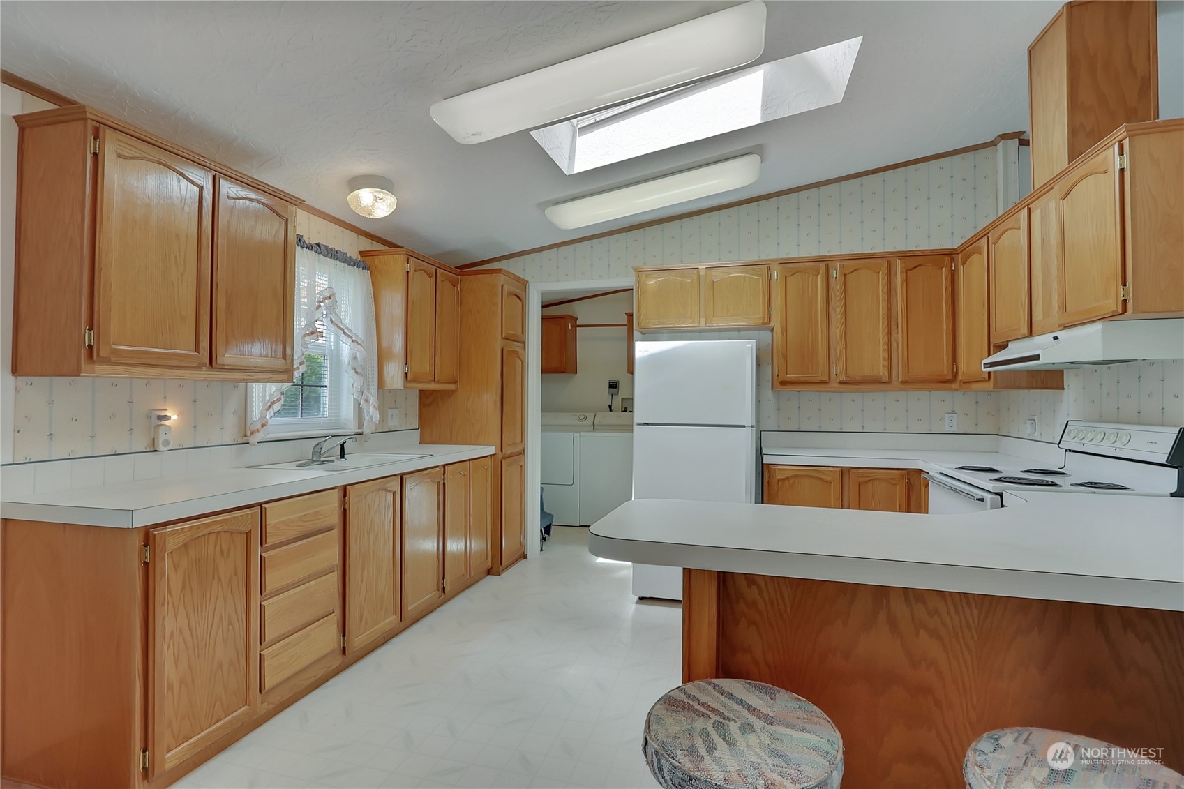 43205 196th Avenue Southeast Enumclaw, WA 98022 - Photo 15 of 30 a kitchen with stainless steel appliances granite countertop a sink refrigerator and cabinets