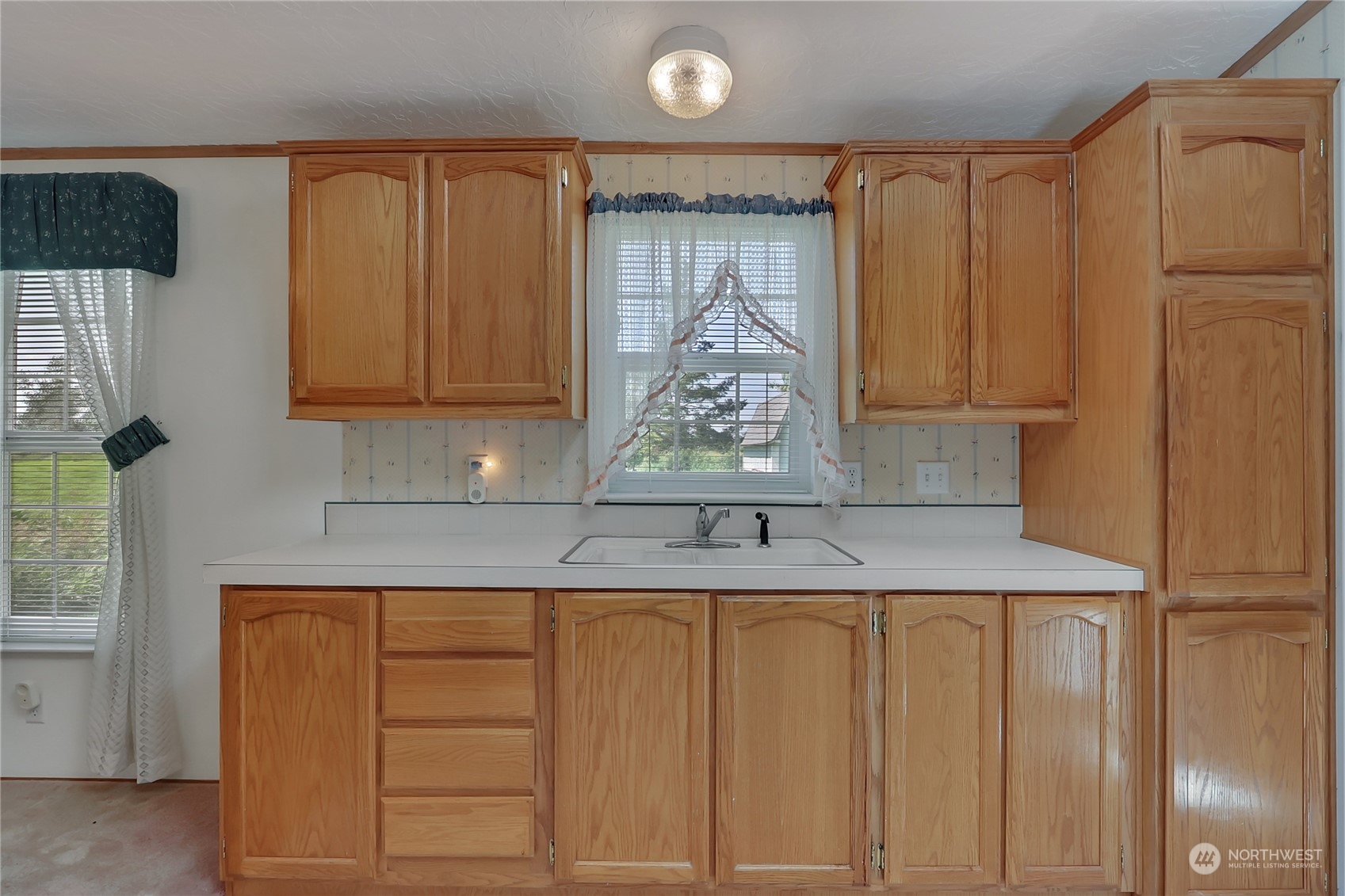 43205 196th Avenue Southeast Enumclaw, WA 98022 - Photo 18 of 30 a kitchen with a sink and cabinets
