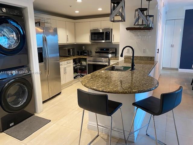 7270 Southwest 88th Street, Unit B306 Miami, FL 33156 - Photo 3 of 25 a kitchen with stainless steel appliances granite countertop a stove a sink and a refrigerator