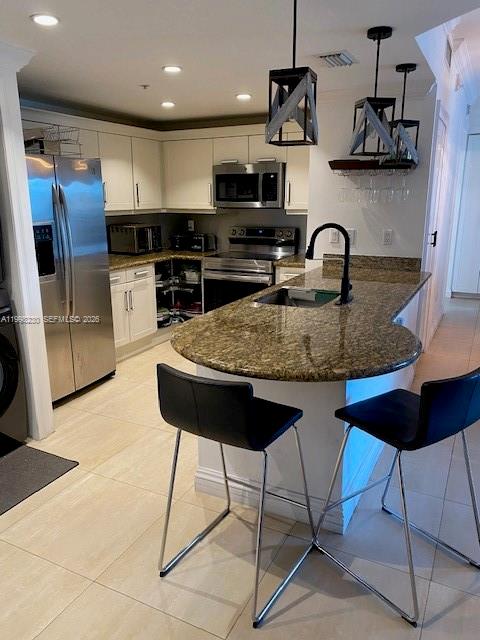 7270 Southwest 88th Street, Unit B306 Miami, FL 33156 - Photo 4 of 25 a kitchen with stainless steel appliances granite countertop a sink a stove a microwave a refrigerator and cabinets
