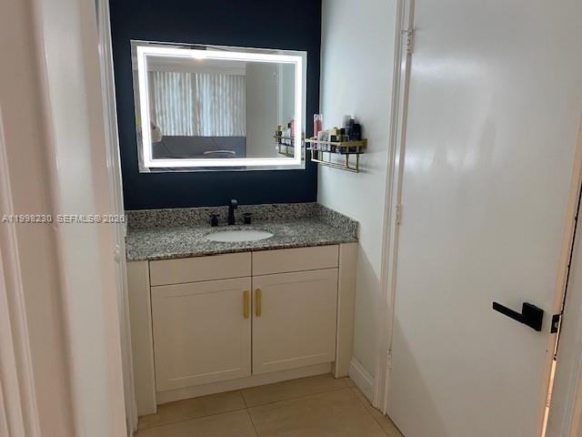 7270 Southwest 88th Street, Unit B306 Miami, FL 33156 - Photo 9 of 25 a bathroom with a granite countertop sink and a mirror