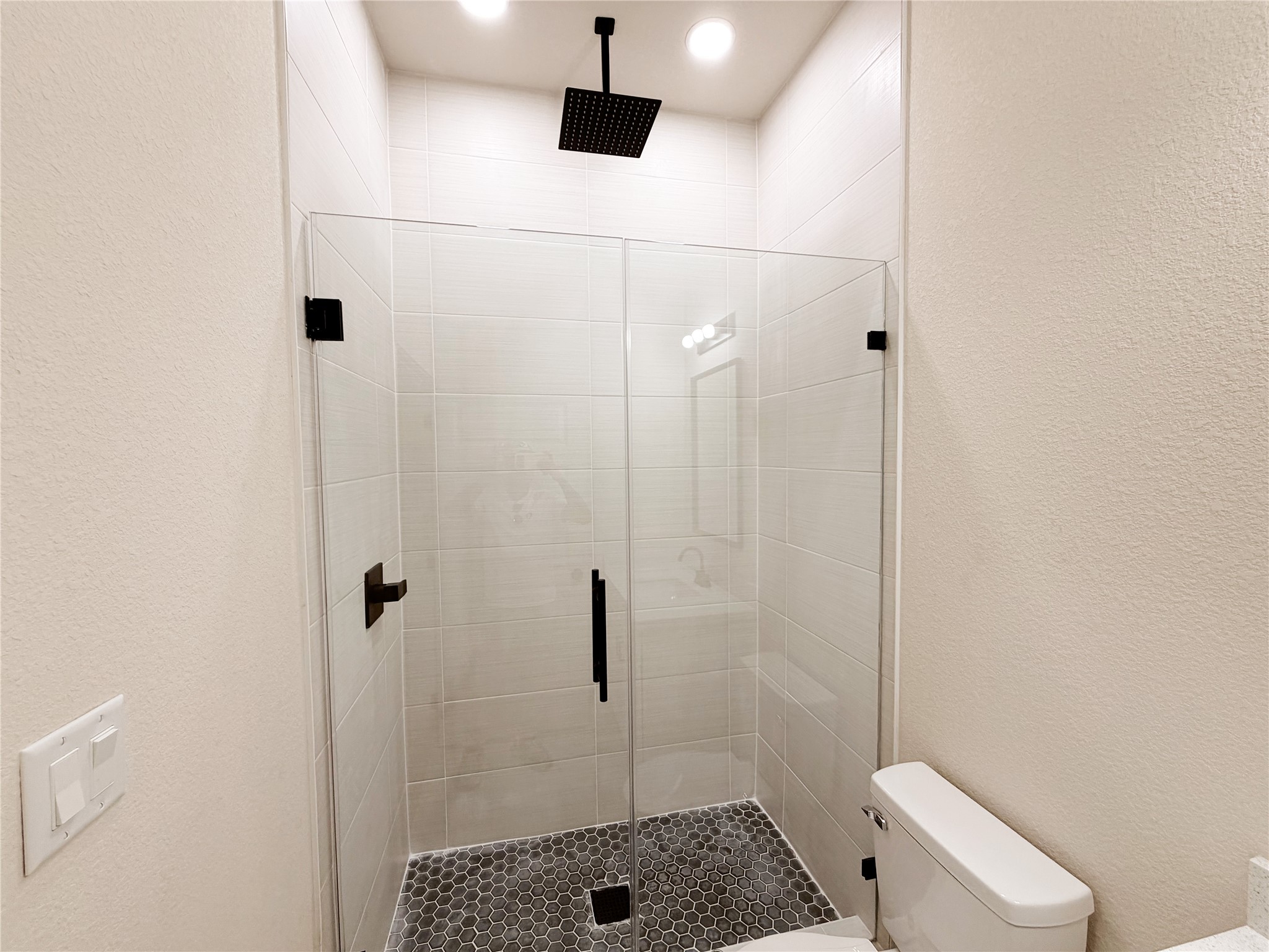 9744 Garcroft Street Houston, TX 77029 - Photo 13 of 17 a bathroom with a shower a toilet and sink