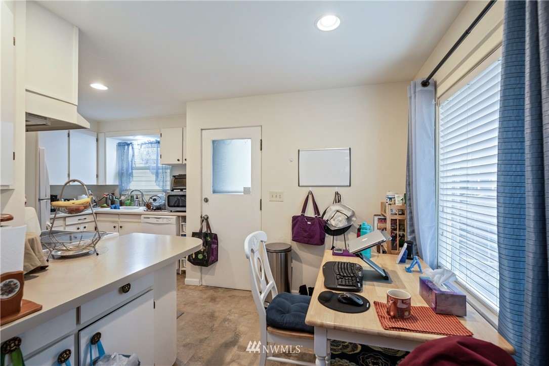 929 North 35th Street Seattle, WA 98103 - Photo 6 of 17 a kitchen with a sink appliances and cabinets
