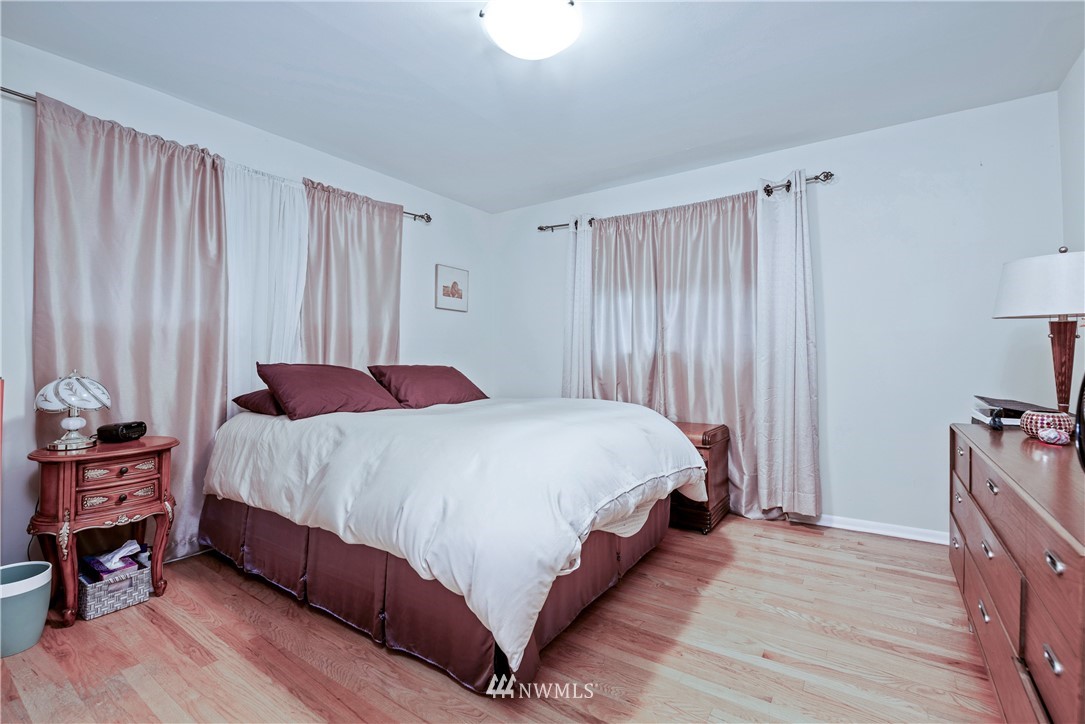 929 North 35th Street Seattle, WA 98103 - Photo 9 of 17 a bedroom with a bed and wooden floor