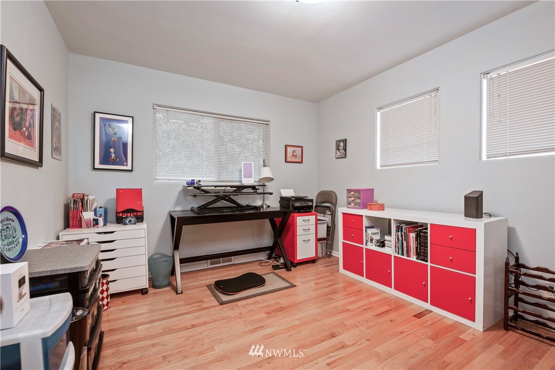 929 North 35th Street Seattle, WA 98103 - Photo 10 of 17 a bedroom with furniture and a wooden floor
