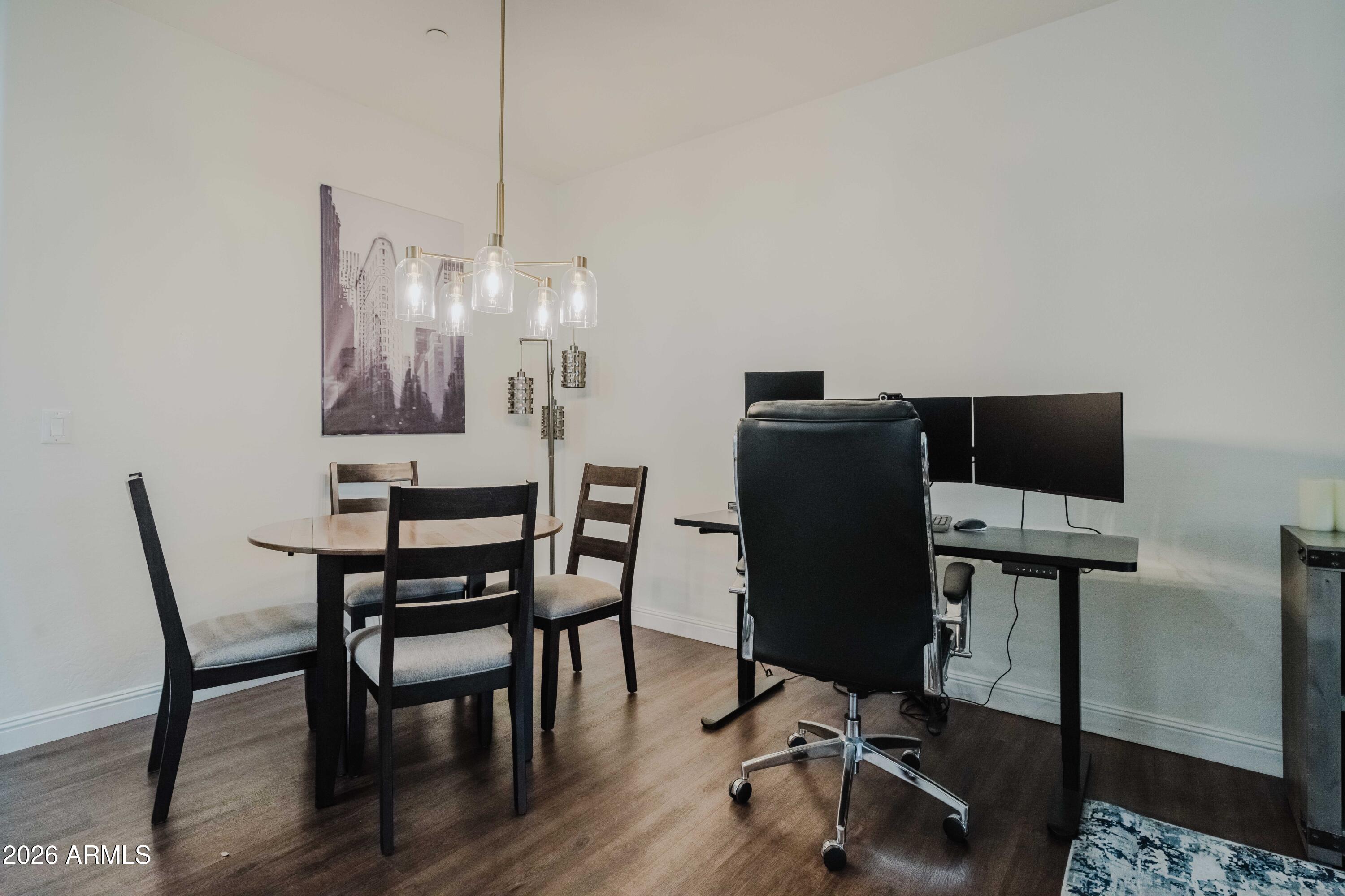 5550 North 16th Street, Unit 131 Phoenix, AZ 85016 - Photo 11 of 25 a view of a dining room with furniture and wooden floor