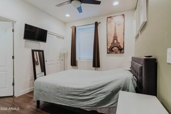 a bedroom with a bed and a flat screen tv