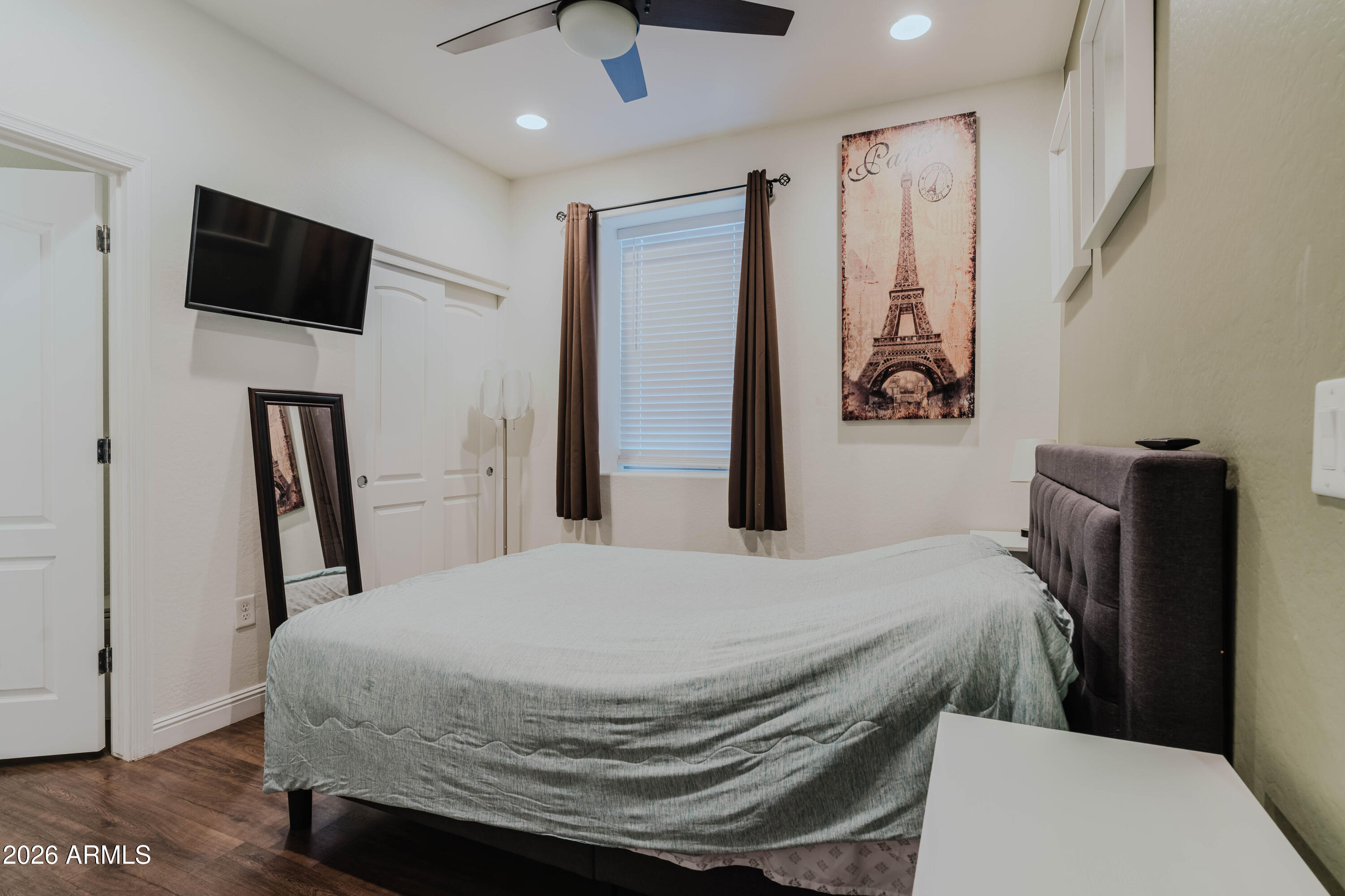 5550 North 16th Street, Unit 131 Phoenix, AZ 85016 - Photo 12 of 25 a bedroom with a bed and a flat screen tv