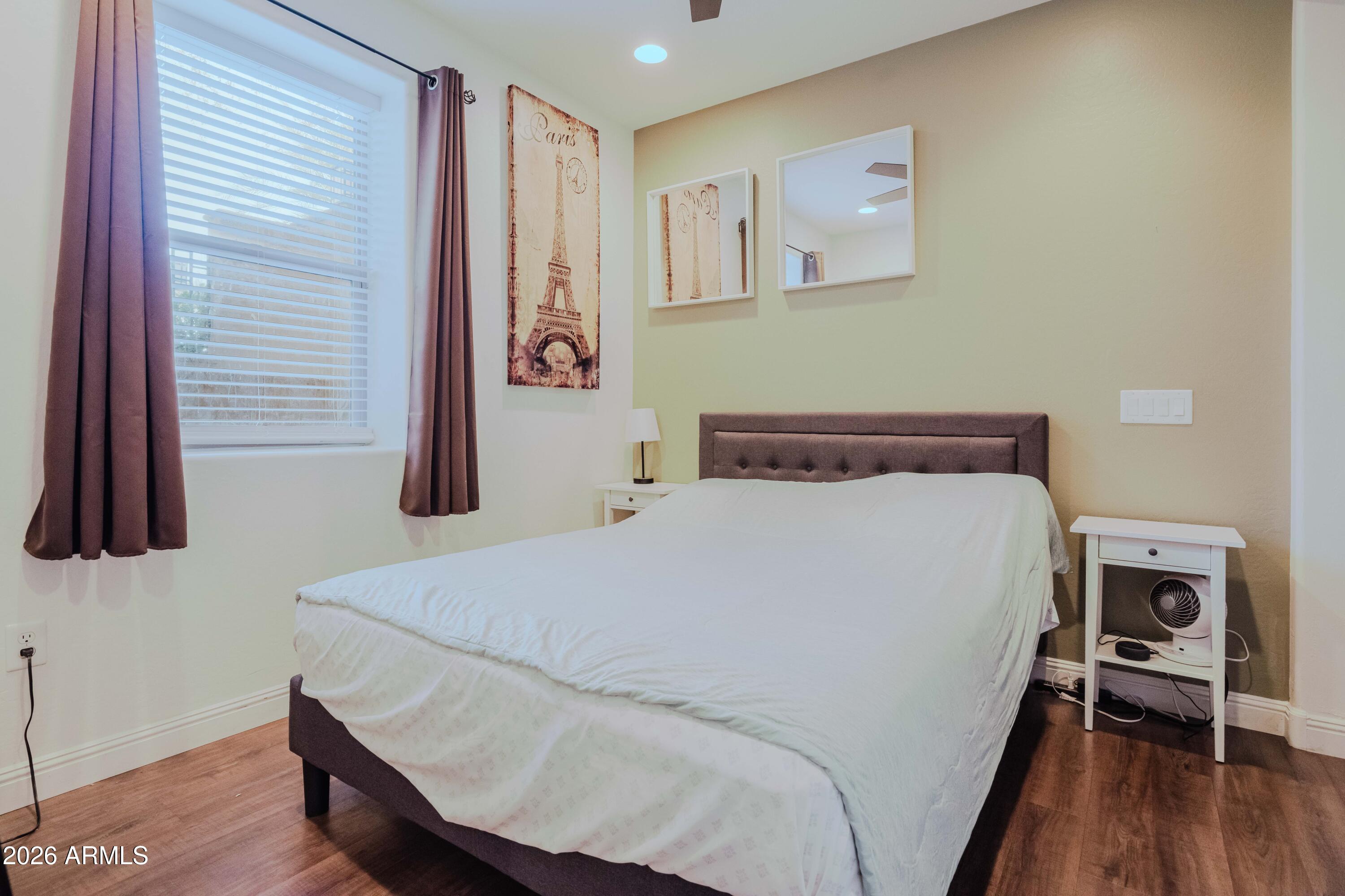 5550 North 16th Street, Unit 131 Phoenix, AZ 85016 - Photo 14 of 25 a bed sitting in a bedroom next to a window