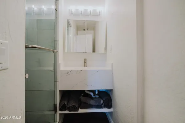 a bathroom with a sink and a mirror
