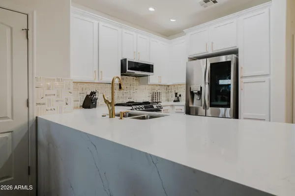 a kitchen with a sink a stove and cabinets