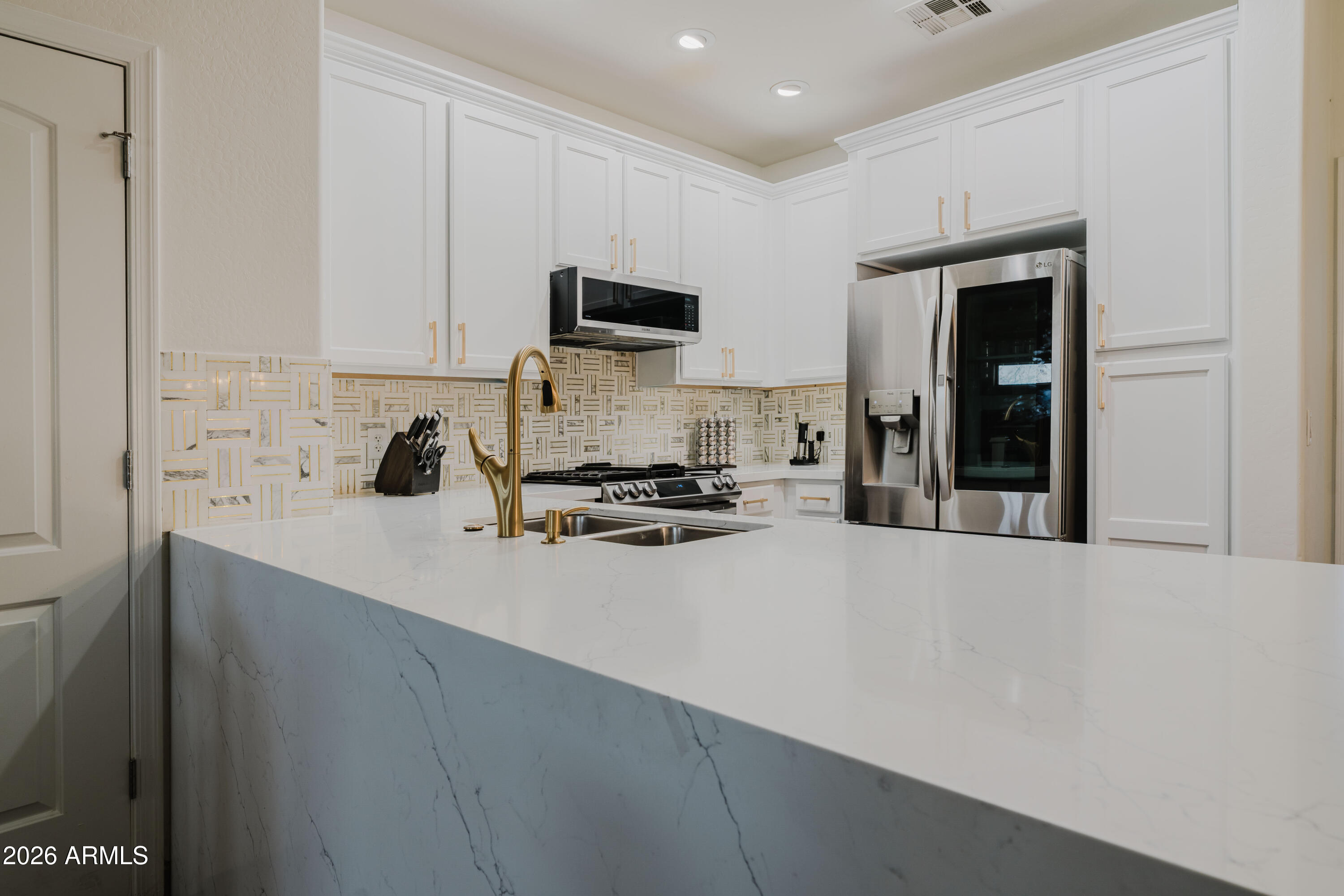 5550 North 16th Street, Unit 131 Phoenix, AZ 85016 - Photo 4 of 25 a kitchen with a sink a stove and cabinets