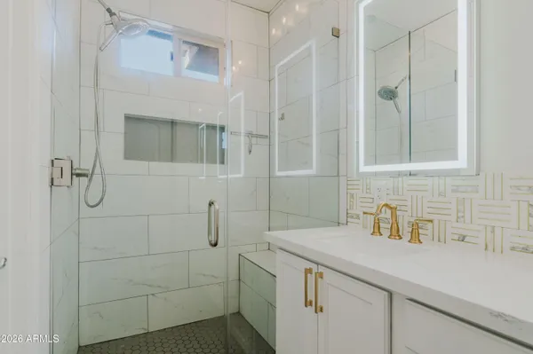 a bathroom with a shower sink and vanity