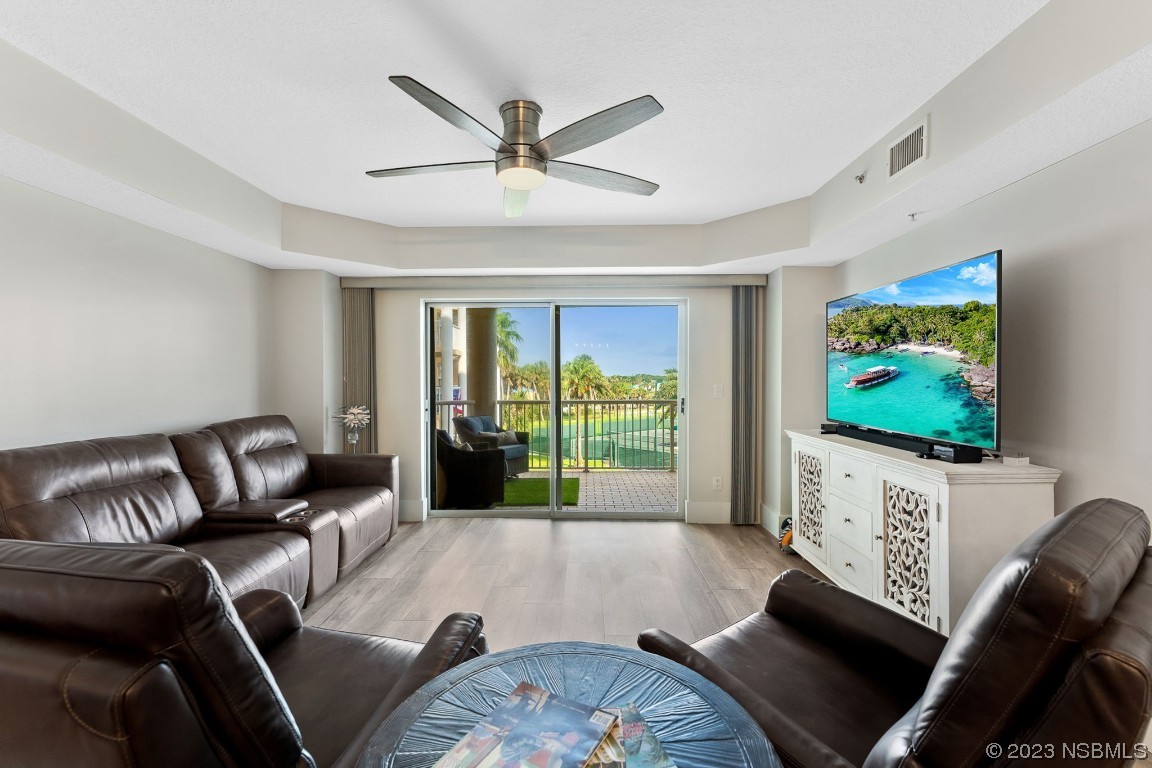 4650 Links Village Drive, Unit A301 Ponce Inlet, FL 32127 - Photo 12 of 54 a living room with furniture a ceiling fan and a flat screen tv