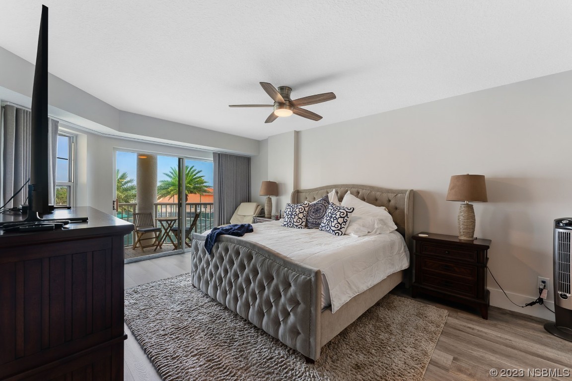 4650 Links Village Drive, Unit A301 Ponce Inlet, FL 32127 - Photo 16 of 54 a bedroom with a bed and wooden floor