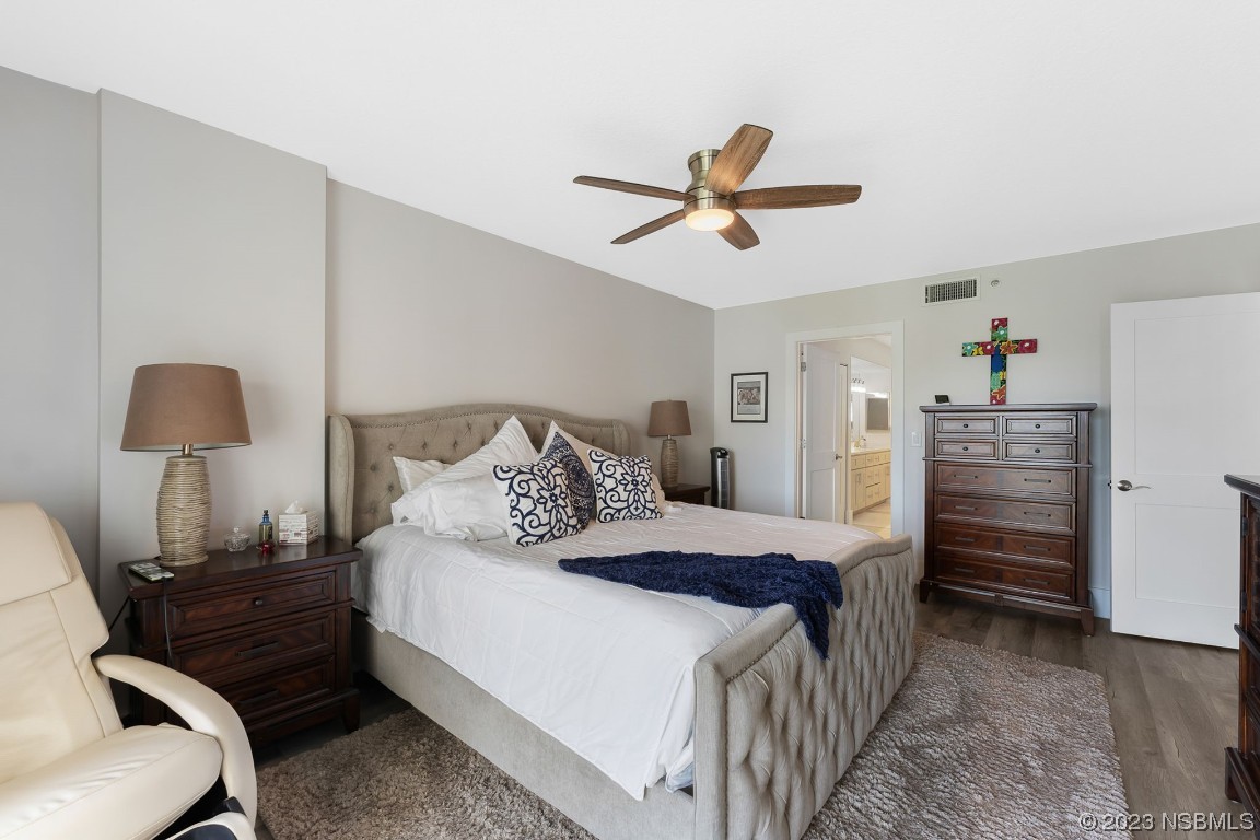 4650 Links Village Drive, Unit A301 Ponce Inlet, FL 32127 - Photo 17 of 54 a bedroom with a bed and a lamp